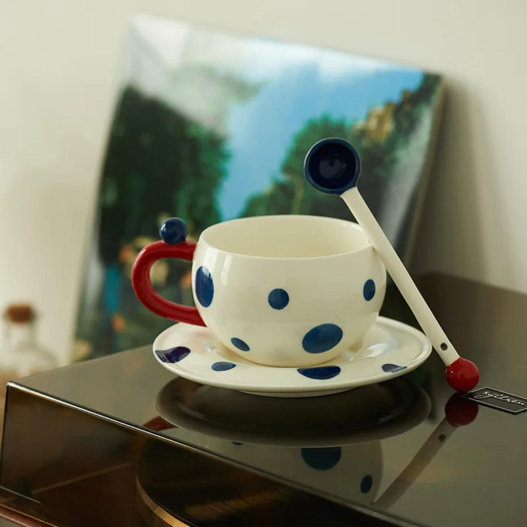 White mug with navy blue dots with spoon