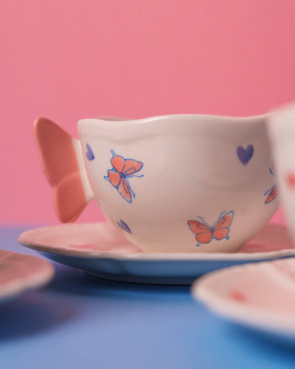 Mug with butterfly handle and saucer