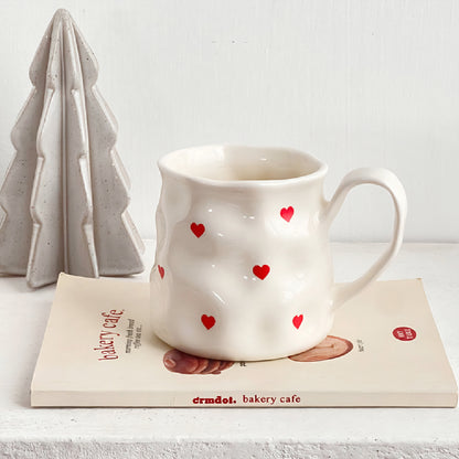 Big white mug with red hearts or bows