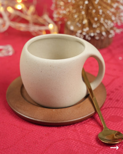 Ceramic coffee cup with spoon and wooden coaster
