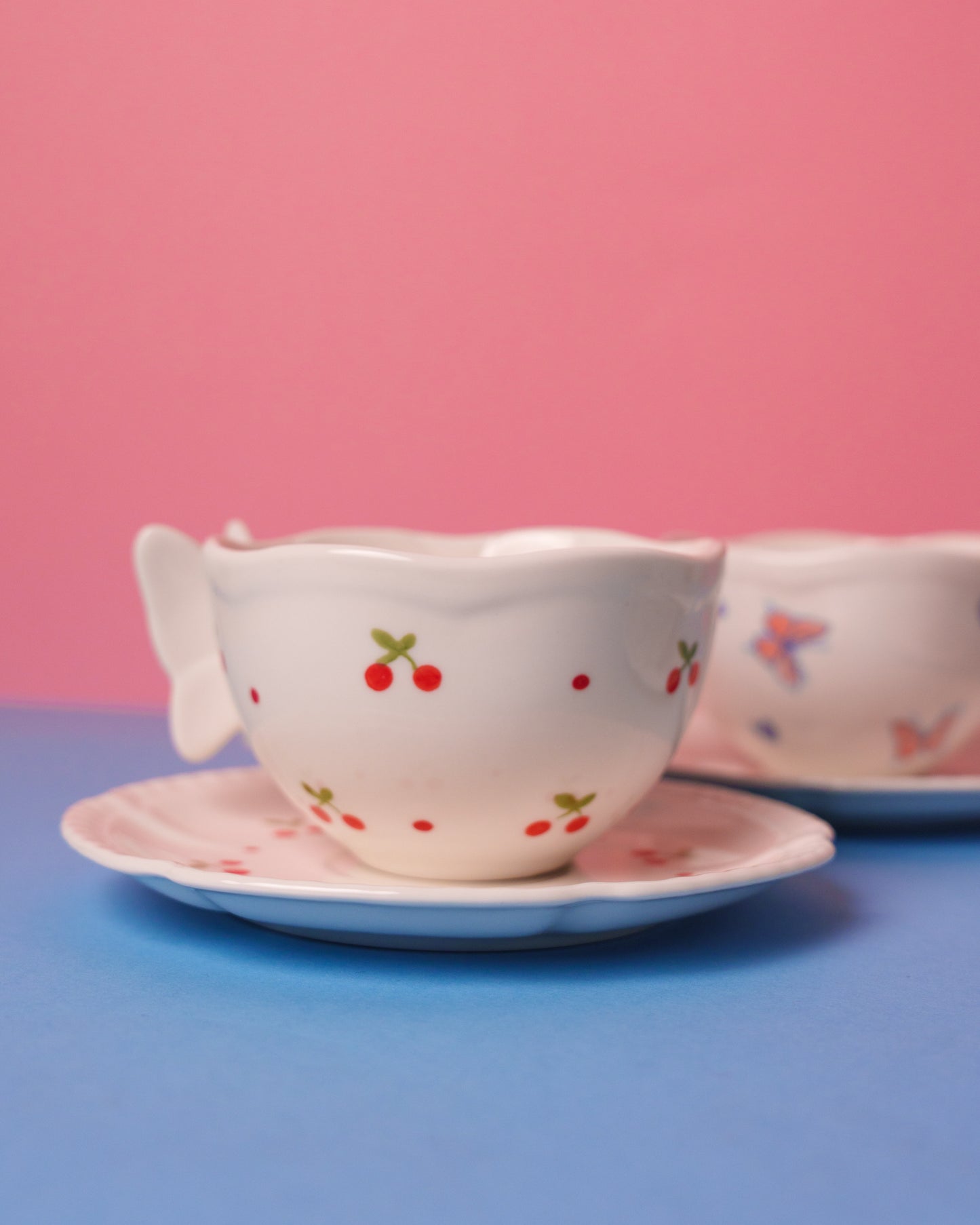Mug with butterfly handle and saucer