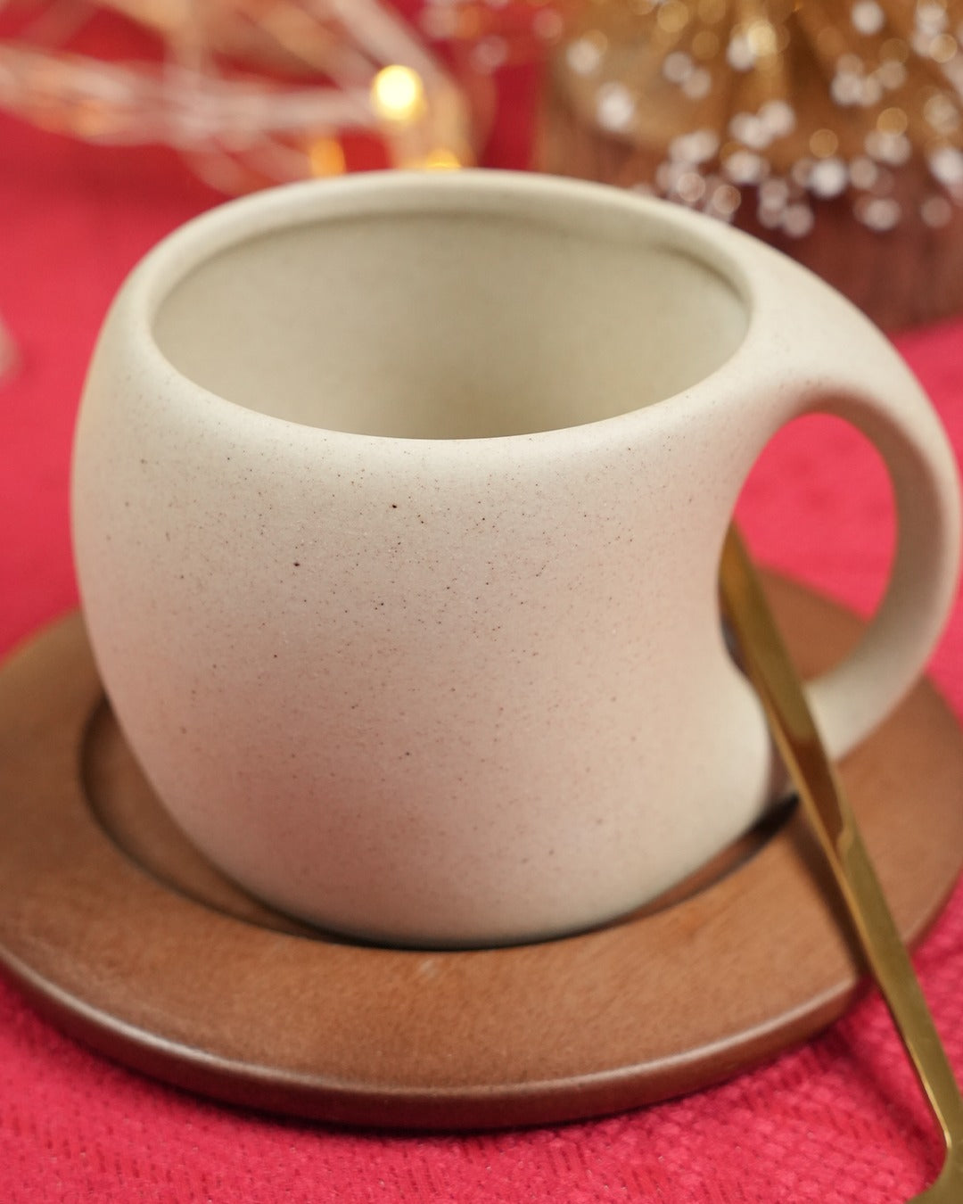 Ceramic coffee cup with spoon and wooden coaster