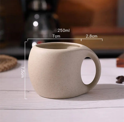 Ceramic coffee cup with spoon and wooden coaster